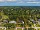 An aerial view of a property with a large lot, mature trees, and a view of the golf course at 3517 Golf Ave., Little River, SC 29566