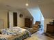 Cozy bedroom with sloped ceilings, a comfortable chair, and wood floors at 3517 Golf Ave., Little River, SC 29566