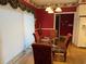 Dining room boasts a glass table, ornate chairs, and elegant window treatments at 3517 Golf Ave., Little River, SC 29566