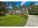 Beautiful brick home featuring an expansive green lawn and mature landscaping at 3517 Golf Ave., Little River, SC 29566