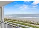 Balcony view featuring a pristine beach, blue skies, and the tranquil ocean at 1207 S Ocean Blvd. # 20304, Myrtle Beach, SC 29577