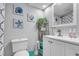 Well-lit bathroom with white cabinets, a decorative mirror, and coordinated seashell decor at 1207 S Ocean Blvd. # 20304, Myrtle Beach, SC 29577