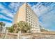 Towering multi-story building with multiple balconies and tropical landscaping at 1207 S Ocean Blvd. # 20304, Myrtle Beach, SC 29577