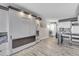 Open-concept living area showing murphy bed, kitchen, dining area, and laminate floors at 1207 S Ocean Blvd. # 20304, Myrtle Beach, SC 29577