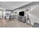 Living room/kitchen combo with breakfast bar, television, laminate floor, and galley kitchen at 1207 S Ocean Blvd. # 20304, Myrtle Beach, SC 29577
