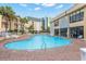 Large community pool with surrounding lounge chairs and palm trees at 1207 S Ocean Blvd. # 20304, Myrtle Beach, SC 29577