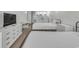 Bright bedroom features two beds, a dresser with TV, a table and chairs, and a compact, efficient kitchen at 1207 S Ocean Blvd. # 20308, Myrtle Beach, SC 29577