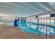 Bright indoor pool area features steps into the pool and many lounge chairs surrounding it for ultimate relaxation at 1207 S Ocean Blvd. # 20308, Myrtle Beach, SC 29577