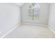 Cozy bedroom with vaulted ceiling, neutral carpet, and large arched window with blinds at 629 Slash Pine Ct., Myrtle Beach, SC 29579