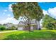 Inviting two-story home with a brick and siding facade and a well-manicured lawn, shaded by a mature tree at 629 Slash Pine Ct., Myrtle Beach, SC 29579