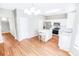 Modern kitchen featuring white cabinets, stainless steel appliances, a center island with seating, and wood flooring at 629 Slash Pine Ct., Myrtle Beach, SC 29579