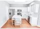 Stylish kitchen featuring white cabinets, stainless steel appliances, a quartz-topped island, and wood-look floors at 629 Slash Pine Ct., Myrtle Beach, SC 29579