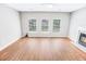 Spacious living room with hardwood floors, a cozy fireplace, three windows, and plenty of natural light at 629 Slash Pine Ct., Myrtle Beach, SC 29579