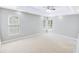 Bright primary bedroom with carpet, ceiling fan, and three windows that provide plenty of natural light at 629 Slash Pine Ct., Myrtle Beach, SC 29579