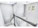 A well lit staircase featuring an ornate chandelier and a modern design that leads to the upper floors at 629 Slash Pine Ct., Myrtle Beach, SC 29579
