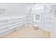Spacious walk-in closet with custom shelving, a small vanity, and carpeted floors at 629 Slash Pine Ct., Myrtle Beach, SC 29579