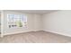 Sunlit bedroom featuring neutral carpeting, a bright window, and view of neighborhood at 748 Rupert Dr, Conway, SC 29526