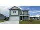 Charming two-story home with a two-car garage, manicured lawn, and attractive green siding at 748 Rupert Dr, Conway, SC 29526