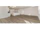Open-concept living room and kitchen boasts wood floors and modern fixtures at 748 Rupert Dr, Conway, SC 29526