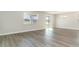 Spacious living room with wood flooring, large windows, and sliding glass doors to the backyard at 748 Rupert Dr, Conway, SC 29526