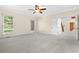 A bedroom shows neutral carpet, white paint, ceiling fan and natural light from windows at 9325 Cove Dr., Myrtle Beach, SC 29572