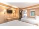 Bedroom featuring a TV, closet with safe, and a glimpse into the kitchen at 1501 South Ocean Blvd. # 644, Myrtle Beach, SC 29577