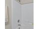 Bathroom featuring an all-white tiled shower-tub combo with a shower head, faucet, and built-in shelves at 1100 Commons Blvd. # 104, Myrtle Beach, SC 29572