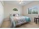Cozy bedroom with a ceiling fan, large window, and comfortable bed, creating a relaxing retreat space at 1100 Commons Blvd. # 104, Myrtle Beach, SC 29572