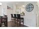 Stylish dining room with bar stool seating and a decorative wall clock adjacent to the kitchen at 1100 Commons Blvd. # 104, Myrtle Beach, SC 29572