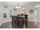 Dining area with wooden table set for six, adjacent to a kitchen and with natural lighting at 1100 Commons Blvd. # 104, Myrtle Beach, SC 29572