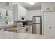 Well-lit kitchen with white cabinets, updated appliances, and tan countertops at 1100 Commons Blvd. # 104, Myrtle Beach, SC 29572