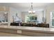 Bright and airy living room with comfortable seating, open to the dining area, with sliding glass doors to patio at 1100 Commons Blvd. # 104, Myrtle Beach, SC 29572