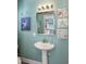 Small bathroom with pedestal sink, shower, and beach-themed decor at 1612 Edge Dr., North Myrtle Beach, SC 29582