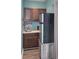 Small kitchenette with refrigerator, microwave, and wooden cabinets at 1612 Edge Dr., North Myrtle Beach, SC 29582