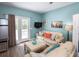 Living room features light beige couch, coffee table, and access to deck at 1612 Edge Dr., North Myrtle Beach, SC 29582
