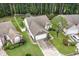 Overhead shot of a well-maintained home with driveway, manicured lawns, and mature trees at 376 Mckendree Ln., Myrtle Beach, SC 29579