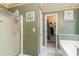 Bathroom featuring a shower, tub, and walk-in closet with green walls and decorative border at 376 Mckendree Ln., Myrtle Beach, SC 29579