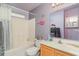 Bathroom featuring a bathtub, shower, and vanity with a large mirror, plus purple-painted walls at 376 Mckendree Ln., Myrtle Beach, SC 29579