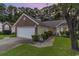Charming home with a well-manicured front yard, brick accents, and attached two-car garage and driveway at 376 Mckendree Ln., Myrtle Beach, SC 29579