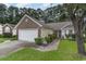 Charming home with a well-manicured front yard, brick accents, and attached two-car garage and driveway at 376 Mckendree Ln., Myrtle Beach, SC 29579