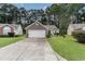 Beautiful exterior view of home with manicured lawn, brick accents, driveway, and large shade tree at 376 Mckendree Ln., Myrtle Beach, SC 29579
