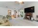 Open-concept living room with vaulted ceilings, fireplace, and views into sunroom and kitchen at 376 Mckendree Ln., Myrtle Beach, SC 29579