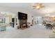 Spacious living room with fireplace and large wall-mounted television, and view into kitchen at 376 Mckendree Ln., Myrtle Beach, SC 29579