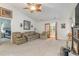 Bright living room featuring neutral walls and carpet, ceiling fan, and door leading to bedroom at 376 Mckendree Ln., Myrtle Beach, SC 29579