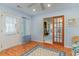 Light-filled sunroom with wood floors, connecting to living room via door with glass panels at 376 Mckendree Ln., Myrtle Beach, SC 29579