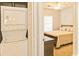 A glimpse of a cozy bedroom from the laundry area shows convenience and comfort at 2060 Cross Gate Blvd. # 305, Surfside Beach, SC 29575