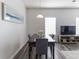 Dining area with modern decor and a large window providing ample natural light, adjoining living area at 2060 Cross Gate Blvd. # 305, Surfside Beach, SC 29575
