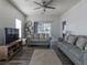 Spacious living area with two couches, a ceiling fan, a tv, and a sliding glass door to a patio at 2060 Cross Gate Blvd. # 305, Surfside Beach, SC 29575