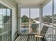 Outdoor patio with seating, perfect for relaxing and enjoying the community pond view at 2060 Cross Gate Blvd. # 305, Surfside Beach, SC 29575