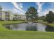 Scenic view of a pond with a fountain, surrounded by lush lawns and apartment buildings at 2060 Cross Gate Blvd. # 305, Surfside Beach, SC 29575